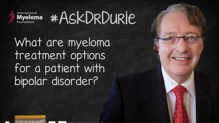 Dr. Durie in front of a chalk board