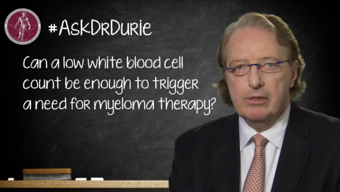 Dr. Brian G.M. Durie in front of a chalk board